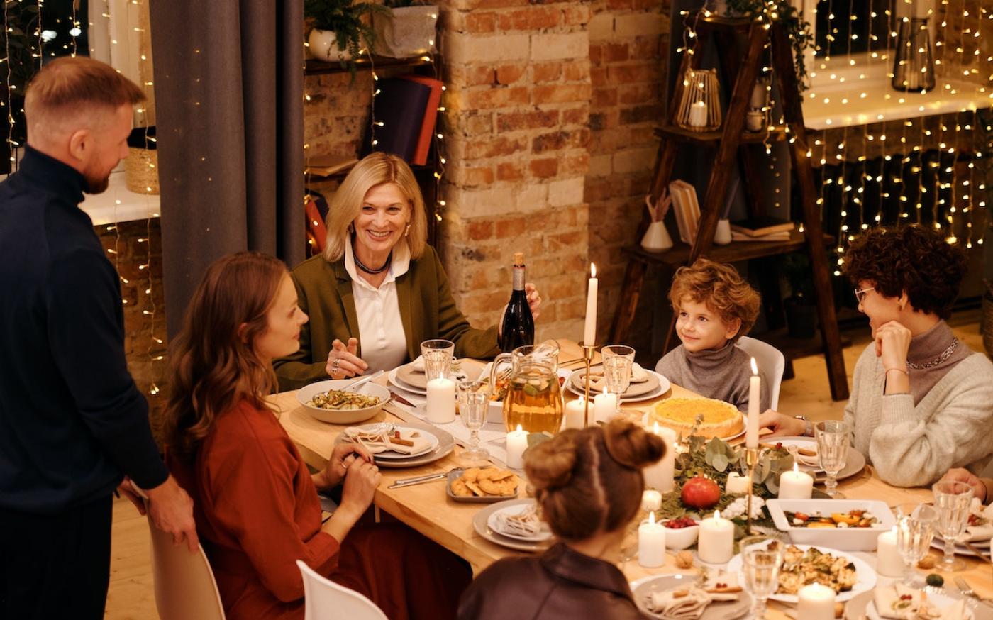 Family sitting at a table together for a holiday dinner